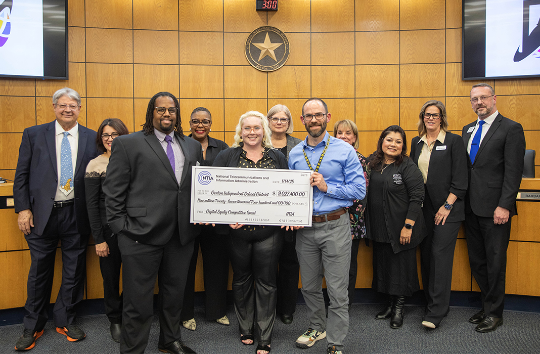 People and trustees holding a check